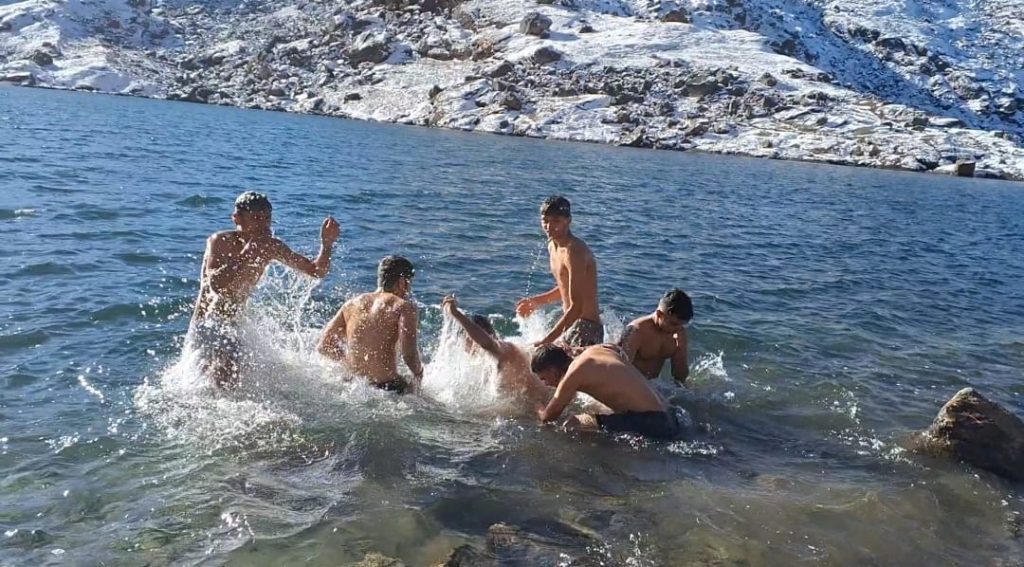 Taking Holy dip in Gosaikunda Lake